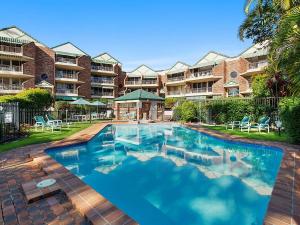 a swimming pool in front of a apartment complex at San Chelsea 8 in Gold Coast