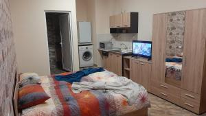 a bedroom with a bed and a tv in it at Арт in Sliven