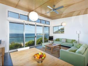 a living room with a view of the ocean at Sea Shack in Seal Rocks