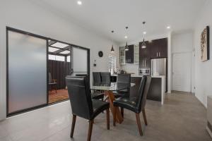a dining room and kitchen with a table and chairs at Chic 2 Bedroom Keilor in St Albans
