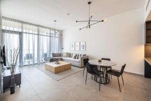 a living room with a couch and a table at Modern 1 Bed in Ellington DT1 Downtown in Dubai