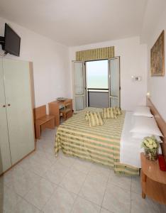 Postel nebo postele na pokoji v ubytování Hotel Rex