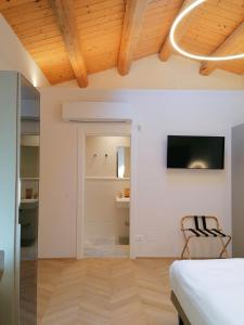 a bedroom with a bed and a tv on a wall at Palazzo Cortesi in Macerata