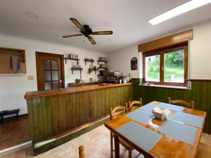 a kitchen with a wooden counter and a table at Casa pando 49 in Pando