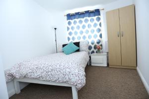 a small bedroom with a bed and a window at 2 Bedroom Apartment in Thamesmead