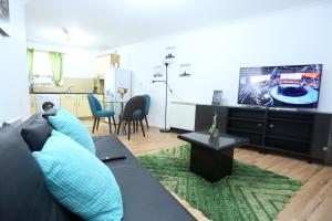 a living room with a couch and a flat screen tv at 2 Bedroom Apartment in Thamesmead