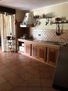 a kitchen with a tiled floor and a counter top at Chorisia Relais in Roccapiemonte