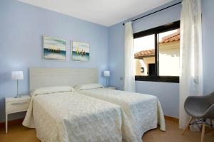 A bed or beds in a room at Villa Pueblo Don Thomas