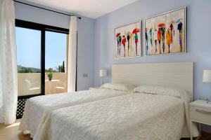 A bed or beds in a room at Villa Pueblo Don Thomas