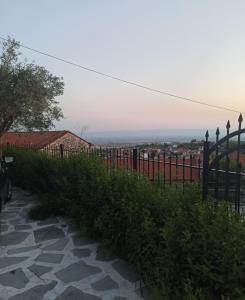 a fence next to a walkway with a view at Pantheon in Serres