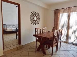 a dining room with a wooden table and chairs at Pantheon in Serres