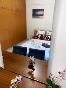 a room with a dining table and a bed at Larnaca Beach Apartment in Larnaca