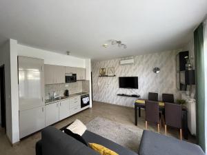 a living room with a couch and a table and a kitchen at Zamardiresort in Zamárdi