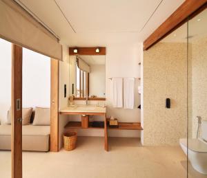 a bathroom with a sink and a toilet and a tub at Riff Hikkaduwa in Hikkaduwa