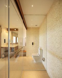 a bathroom with a toilet and a glass shower at Riff Hikkaduwa in Hikkaduwa
