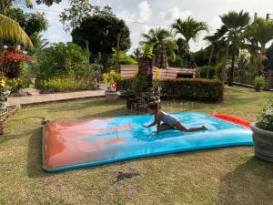 a little girl playing on an inflatable pool at The Orchard Holiday Home in Mahe