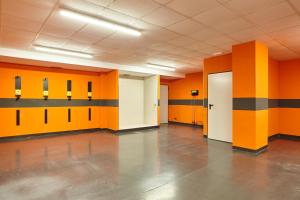 an empty room with orange and black walls at Hotel Torre del Mar - Ibiza in Playa d'en Bossa