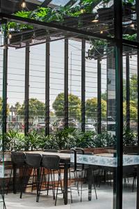 a greenhouse with tables and chairs and plants at Mantra Traralgon in Traralgon