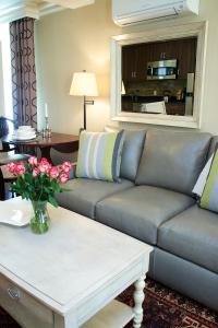 a living room with a couch and a table with flowers at Guest House at Norwalk Inn in Norwalk