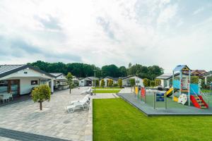 a park with a playground with a slide at Duet Domki in Jarosławiec