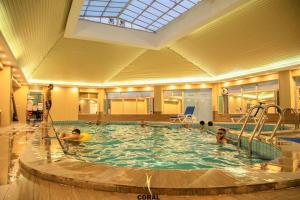 a group of people in a swimming pool at Coral Palace Hotel in Baghdād