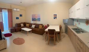a kitchen and living room with a couch and a table at Premium Apartaments 02-03 in Vlorë