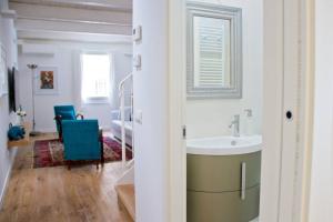 a white bathroom with a sink and a room at Casa Vicolo Castello in Ravenna +27 photos