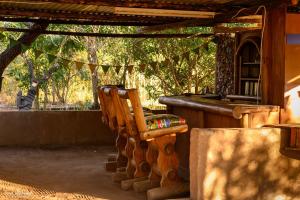 a wooden chair sitting in front of a building at Shik Shack Backpackers in Guernsey Nature Reserve