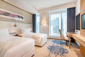 Jouri a Murwab hotel Doha客房内的一张或多张床位