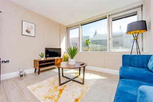 a living room with a blue couch and a table at SEAVIEW I ONE BEDROOM FLAT I CENTRAL BRIGHTON LOCATION GDTF in Brighton & Hove