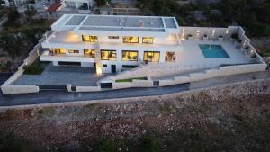 an aerial view of a house with a swimming pool at Sea Star Villa - Vinjerac in Vinjerac