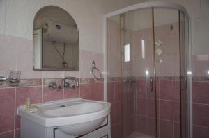 a bathroom with a sink and a shower at Lenny in Kranevo +42 photos