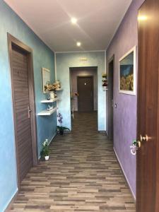um corredor com paredes azuis e roxas e um corredor com um corredor em B&B Pirro Malena em Casa Toscano