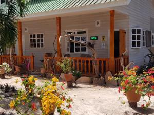 a house with potted plants in front of it at Villa Charette-Self Catering Villas in La Digue