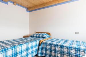 Postel nebo postele na pokoji v ubytování Baita Località Cap