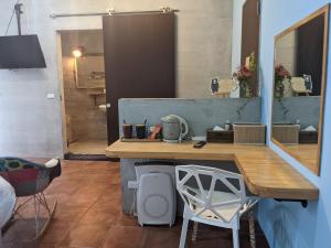 a room with a counter with a table and a mirror at Ttdropin Homestay in Taitung City