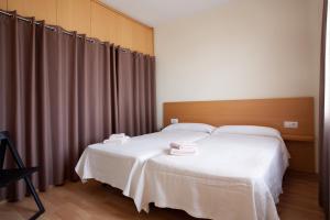 a bedroom with a bed with two towels on it at RIUS - Modern apartment in the Montjuic in Barcelona