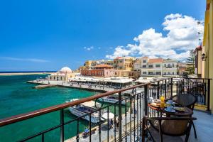 a balcony with a view of the water and a harbor at Belmondo Hotel in Chania