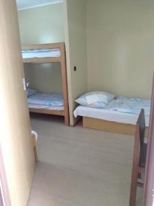 a small room with two bunk beds in it at Chatová osada OKÁL in Patince