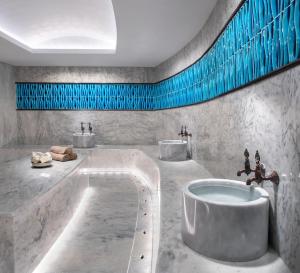 a bathroom with two sinks and a large tub at Radisson Collection Hotel, Bodrum in Akyarlar