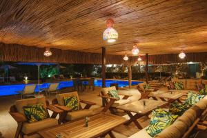 a restaurant with couches and tables and a pool at Lemon Garden Türkbükü in Türkbükü