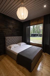 a bedroom with a large bed and a large window at Abna Hotel in Pizunda