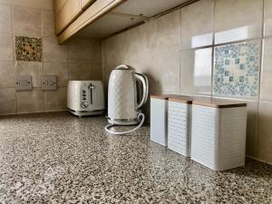 a kitchen with a toaster and a coffee maker at Beachfront Panoramic Seaview Free Wifi & Parking in Lossiemouth +25 photos