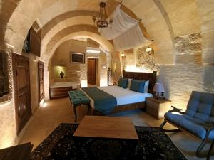 a large bedroom with a bed and a couch and a room at Pegas Cave Suites in Urgup