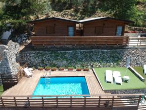a house with a swimming pool and a cabin at Relais Buona Stella in Pimonte