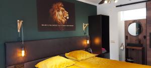 a bedroom with a bed with a picture of a horse on the wall at B&B de Droomgaard in Kerkdriel