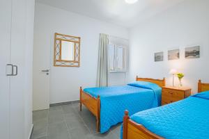 a bedroom with two beds and a window at Lazaros Centre Apartment in Larnaka