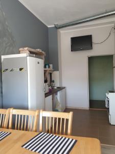 a kitchen with a table and a white refrigerator at Türi Vibukooli majutus in Türi