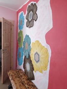 una stanza con un muro con dei fiori di Türi Vibukooli majutus a Türi