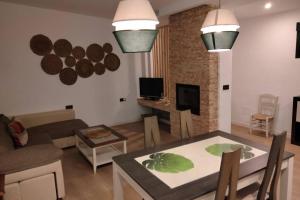 a living room with a table and a dining room at Alojamiento Rural La Viña del Cerezo in Huelma